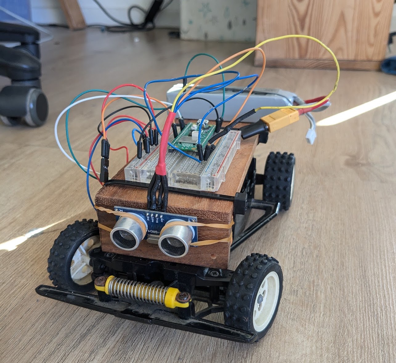 a diy robot with 4 wheels and exposed wiring